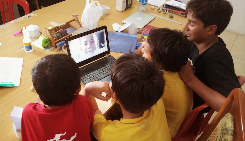 Students watch 'Caine's Arcade' to get ideas for their cardboard creations. (Photo c/o Sam Gibbs)